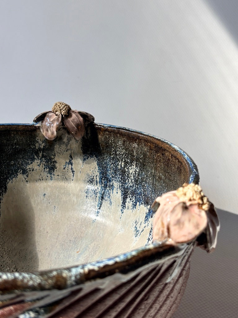 Close-up of a pink handmade placenta bowl with layered floral detail