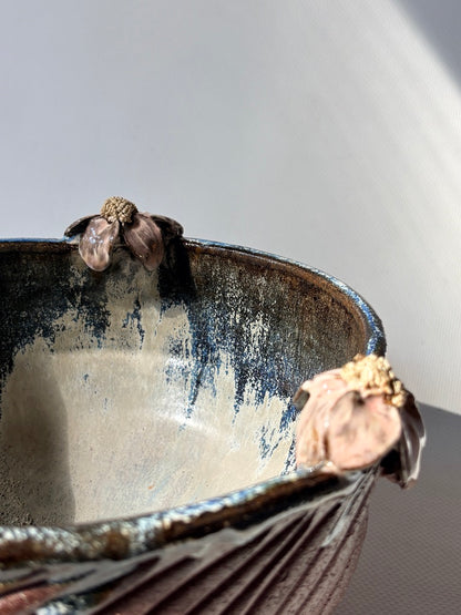 Close-up of a pink handmade placenta bowl with layered floral detail