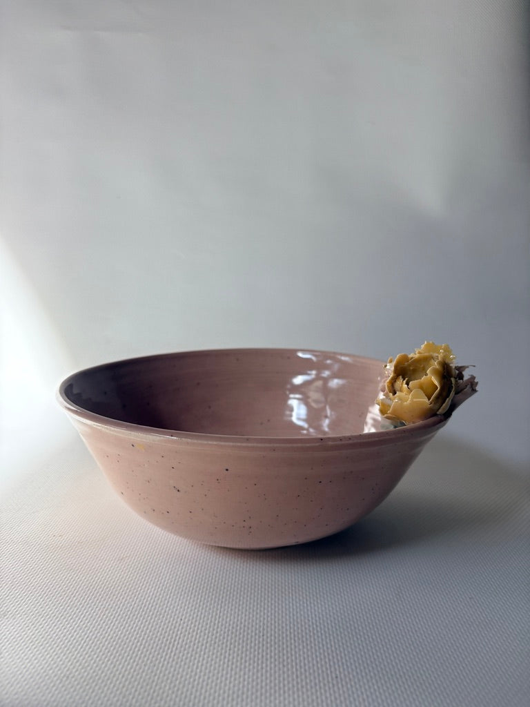 Pink handmade placenta bowl with a yellow flower detail on the rim