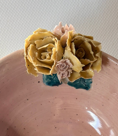 Dark handmade placenta bowl with sculpted floral details on the rim