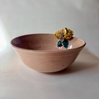 Close up of floral accent on pink celadon bowl