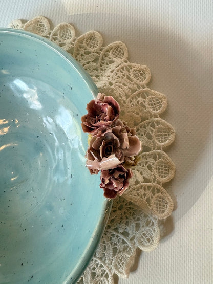 Blue and brown handmade placenta bowl with a textured floral rim