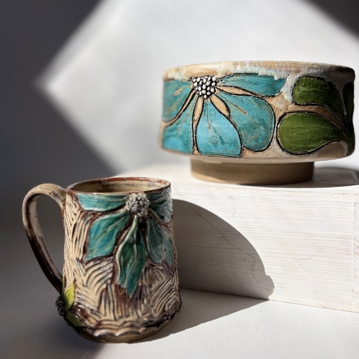 Retro botanical bowl shown alongside matching hand-carved mug